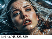 The girl is wrapped in cellophane or a bag. The girl is suffocating. Plastic pollution of the planet. Environmental hazard. Reducing the reuse of plastic. Recycling. The concept of garbage. Стоковое AI-изображение, AI-художник Photojuli / Фотобанк Лори