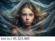 The girl is wrapped in cellophane or a bag. The girl is suffocating. Plastic pollution of the planet. Environmental hazard. Reducing the reuse of plastic. Recycling. The concept of garbage. Стоковое AI-изображение, AI-художник Photojuli / Фотобанк Лори