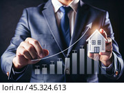 The concept of value growth in real estate, energy efficiency rating. Real estate online on virtual screens. New family housing, apartment purchase, house search, land price, real estate tax. Стоковое AI-изображение, AI-художник Photojuli / Фотобанк Лори