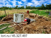 Rigging work to move concrete ring during septic tank installation. Стоковое фото, фотограф Владимир Григорьев / Фотобанк Лори