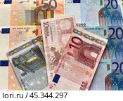Close-up of euro paper banknotes. Euro bills of different denominations are scattered on the table. Money financial background. Flat lay, close-up, top view. Стоковое фото, фотограф Виктория Катьянова / Фотобанк Лори