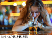Young woman feeling sad and drinking alcohol at bar counter. Стоковое AI-изображение, AI-художник Иван Рябоконь / Фотобанк Лори