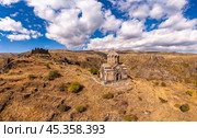 Aerial drone view of famous Vahramashen Church of the 11th century, located near destroyed Amberd fortress in sunny summer day. Cliff with Arkashian River deep in canyon. Aragatsotn region, Armenia. Стоковое фото, фотограф Алексей Ширманов / Фотобанк Лори