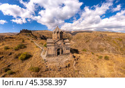 Aerial drone view of famous Vahramashen Church of the 11th century, located near destroyed Amberd fortress in sunny summer day. Cliff with Arkashian River deep in canyon. Aragatsotn region, Armenia. Стоковое фото, фотограф Алексей Ширманов / Фотобанк Лори