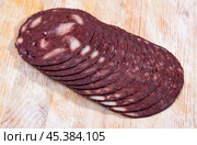 European cuisine blood pudding on white plate on wooden table. Стоковое фото, фотограф Яков Филимонов / Фотобанк Лори