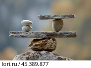 Stone balancing showing concept of justice and law on blurred background. Стоковое AI-изображение, AI-художник Иван Рябоконь / Фотобанк Лори