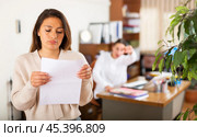 Unhappy woman standing in office after reprimand from chief. Стоковое фото, фотограф Яков Филимонов / Фотобанк Лори