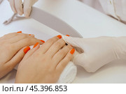 manicure worker smoothing customers nails with nail file. Стоковое фото, фотограф Сергей Толмачёв / Фотобанк Лори