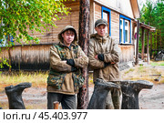 Молодые люди ( манси ), видимо братья , только что вернулись с рыбалки, и опрокинули на просушку свои сапоги ( типичный способ для здешних мест ). Их родовое имение находится в лесу ( недалеко от реки ). Они, коренные жители народов севера - манси, здесь живут годами. Основные продукты - самые, что ни на есть натуральные. Все остальное покупают раз в месяц, в городе. Сообщение с городом круглый год по реке , километров 20-25... (2011 год). Редакционное фото, фотограф Павел Просянов / Фотобанк Лори