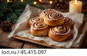 The cinnabons. Close-up of cinnamon buns. Beautiful buns with fresh cinnamon and icing on a wooden table. Fragrant homemade New Year's pastries. Стоковое AI-изображение, AI-художник Photojuli / Фотобанк Лори