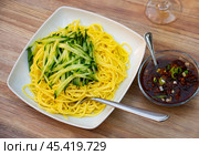 Portion of noodles, supplemented with thinly sliced fresh cucumbers and stewed minced meat. Стоковое фото, фотограф Яков Филимонов / Фотобанк Лори