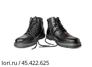 Black boots made of genuine leather with untied laces. Men's winter shoes on a white background. Стоковое фото, фотограф Дмитрий Кобзев / Фотобанк Лори