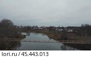 The gray autumn river carries its cold waters under a gloomy cloudy sky. Autumn rural landscape before winter. Стоковое видео, видеограф Ярославский Максим / Фотобанк Лори
