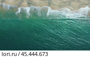 The ocean is calm and the sky is blue. The beach is empty and the waves are small. Стоковое видео, видеограф Дмитрий Брусков / Фотобанк Лори
