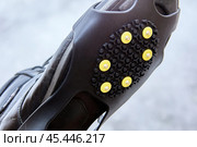 Cleats or crampons that have metal spikes for extra traction on ice, winter walking is safer. Стоковое фото, фотограф Владимир Григорьев / Фотобанк Лори
