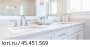 Modern white bathroom vanity with double sinks and chrome faucets. Стоковое AI-изображение, AI-художник Юрий Поздников / Фотобанк Лори