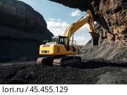 Mining excavator loading coal working in quarry mines open pit under blue sky. Digging machine works in coal mine, hauling minerals. Heavy metallurgy loads mine machinery concept. Copy ad text space. Стоковое AI-изображение, AI-художник Aleksandr Golubev / Фотобанк Лори