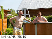 Two brothers pose near their backyard pool. Стоковое фото, фотограф Андрей Аркуша / Фотобанк Лори