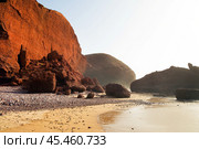 Picturesque rocky beach with red cliffs and boulders in the surf zone. Atlantic Ocean. Sidi Ifni. Morocco. Africa (2024 год). Стоковое фото, фотограф Евгений Ткачёв / Фотобанк Лори