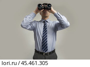 Man in a shirt and tie is spying on someone through binoculars. Стоковое AI-изображение, AI-художник Дмитрий Киселёв / Фотобанк Лори