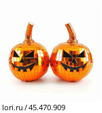 Two mirrored halloween pumpkins grinning on white background. Стоковое AI-изображение, AI-художник Иван Рябоконь / Фотобанк Лори