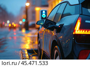 Charging station for recharging the battery with electricity using an EV charging cable in an evening city street. Innovative electric vehicle and energy sustainability. Стоковое AI-изображение, AI-художник Sergey Grishin / Фотобанк Лори