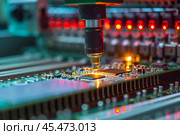 Automatic Pick and Place machine quickly installs Components on Generic Circuit Board. Electronics and Circuit board Manufacturing. Bright Environment. Стоковое AI-изображение, AI-художник Sergey Grishin / Фотобанк Лори
