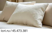 A cushion made of textured boucle fabric, against a background of other pillows. Стоковое AI-изображение, AI-художник Ольга Губская / Фотобанк Лори