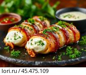 Chicken fillet rolls with mozzarella and herbs, in bacon, incredibly tasty, tender and appetizing. Enjoy your meal! Стоковое AI-изображение, AI-художник Сергей Елизарьев / Фотобанк Лори