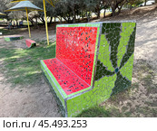 Urban sculpture in Ashdod park. Bench in the form of a cut watermelon in mosaic technique. Редакционное фото, фотограф Irina Opachevsky / Фотобанк Лори