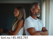 Father and teenage daughter looking in opposite directions after argument. Стоковое AI-изображение, AI-художник Евгений Харитонов / Фотобанк Лори