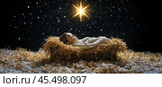 The Christ child lies in a manger made of straw under a dark sky with a bright star. The symbol of Christmas. Стоковое AI-изображение, AI-художник Ярославский Максим / Фотобанк Лори