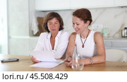 Women are sitting at table with papers and are immensely happy. Стоковое видео, видеограф Яков Филимонов / Фотобанк Лори
