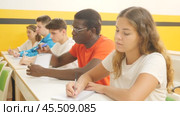 Young woman sitting at desk in classroom of school for taxi drivers. Стоковое видео, видеограф Яков Филимонов / Фотобанк Лори