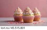 Festive cupcakes, baked with pastry sprinkles on a pink background with sequins, ideal for romantic celebrations. Valentine's Day, wedding. Стоковое AI-изображение, AI-художник Photojuli / Фотобанк Лори
