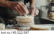 Artisan craftsmanship in cheesemaking: salting cheese wheels for optimal flavor. Стоковое AI-изображение, AI-художник Sabyna75 / Фотобанк Лори