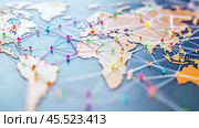 Colorful pins connecting locations on world map showing international trade and travel. Стоковое AI-изображение, AI-художник Юрий Поздников / Фотобанк Лори