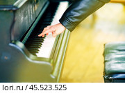 The hand of a child trying to play a street piano. Стоковое фото, фотограф Татьяна Степанищева / Фотобанк Лори
