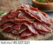 Every year on November 27th, Dried Meat Day is celebrated. The holiday is dedicated to homemade dried meat and simple recipes, the best from generation to generation. Стоковое AI-изображение, AI-художник Сергей Елизарьев / Фотобанк Лори