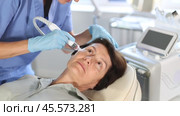 Aged female patient undergoing device-driven facial treatment using ion bubble pen attachment for gentle exfoliation, deep hydration and skin rejuvenation at cosmetic medicine clinic. Стоковое видео, видеограф Яков Филимонов / Фотобанк Лори