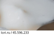 A metal spoon is used to scoop up their yogurt cans. The shooting is very close-up. Стоковое видео, видеограф Ярославский Максим / Фотобанк Лори