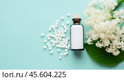 This arrangement showcases homeopathic globules scattered around a glass bottle against a pastel backdrop, highlighting alternative healthcare options with an inviting aesthetic. Стоковое AI-изображение, AI-художник Sergey Grishin / Фотобанк Лори