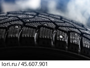 Brand new studded tire with metal studs embedded within the tread. Стоковое фото, фотограф EugeneSergeev / Фотобанк Лори