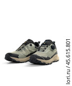 KRASNOYARSK, RUSSIA - December 1, 2024: Beige Merrell sneakers on a white background. Редакционное фото, фотограф Плотников Дмитрий / Фотобанк Лори