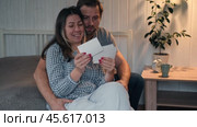 Mature Couple, Wife with Husband looks with interest at a vintage photography. Man and Woman looking at family photos. Genealogy, the memory of ancestors, family ties, memories of childhood. History. Стоковое видео, видеограф Марина Демидюк / Фотобанк Лори