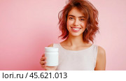 The girl advertises Biologically active additives, medicines. A white jar is in the young woman's hand. Стоковое AI-изображение, AI-художник Ирина Ручушкина / Фотобанк Лори