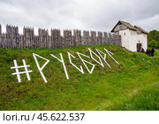 Название фестиваля исторической реконструкции "Русборг" выложено досками перед частоколом крепости (2024 год). Редакционное фото, фотограф Вячеслав Палес / Фотобанк Лори