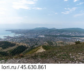 Panoramic view of Novorossiysk City and Tsemess Bay at sunrise. Morning cityscape of large port at Black Sea coast in Russia (2024 год). Стоковое фото, фотограф Фотограф / Фотобанк Лори