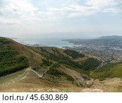 Panoramic view of Novorossiysk City and Tsemess Bay at sunrise. Morning cityscape of large port at Black Sea coast in Russia (2024 год). Стоковое фото, фотограф Фотограф / Фотобанк Лори