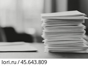 Stacks of documents arranged on a desk during a workday in an office environment. Стоковое AI-изображение, AI-художник Юлия Гапеенко / Фотобанк Лори